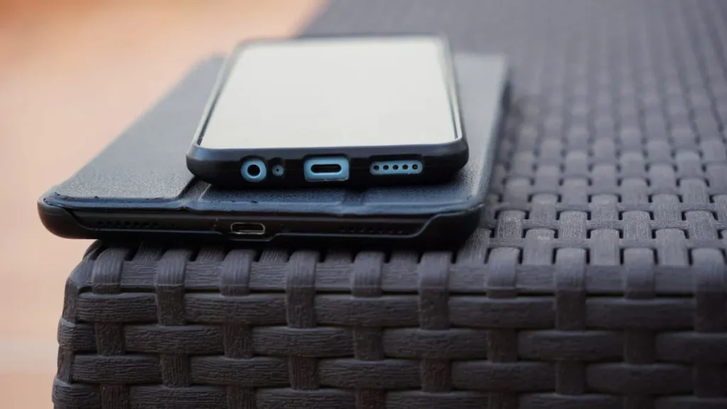 Smartphone in hand showing settings while learning how to back up your phone