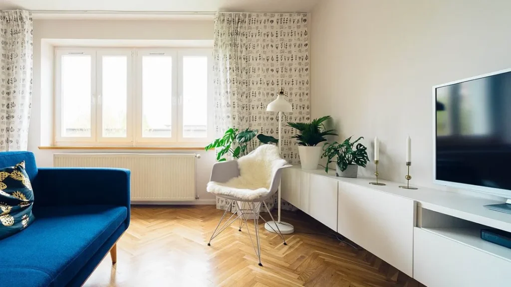 Labeled keep, donate and recycle boxes in a tidy living room, showing how to declutter your home room by room