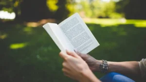 Woman learning how to read more books with coffee and an open paperback