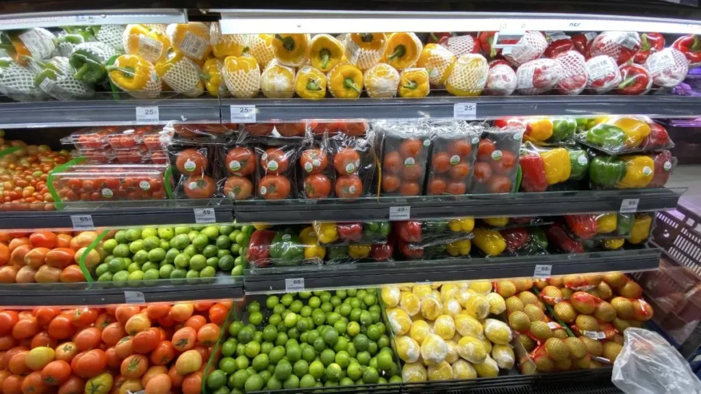 Grocery shopping cart with fresh produce, showing how to save money on groceries