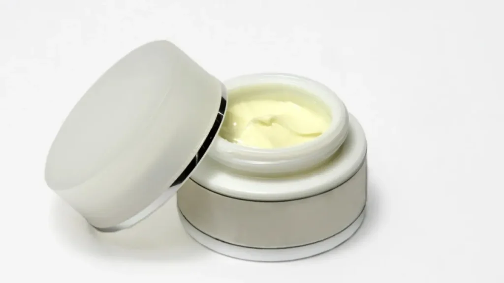 Skincare routine for beginners with cleanser, moisturizer and sunscreen bottles on a bathroom shelf