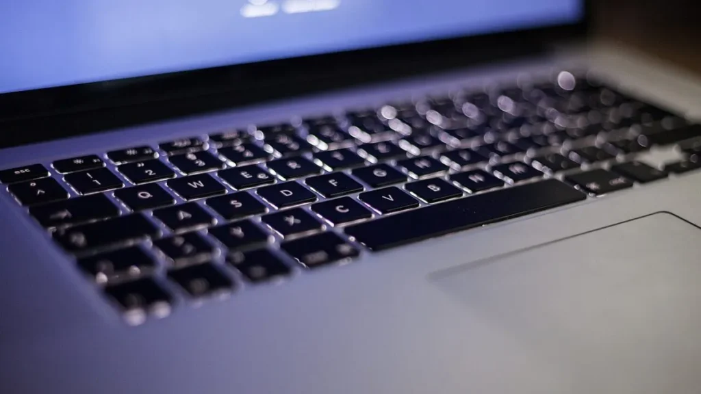 Open laptop on a tidy desk, illustrating how to speed up a slow laptop