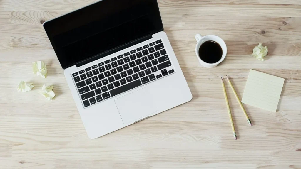 Person working at a tidy home desk with a laptop, illustrating work from home productivity tips